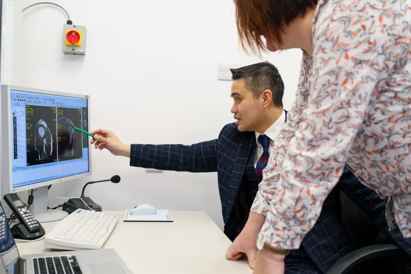 Professor Paul Lee explaining a scan during a clinic conversation